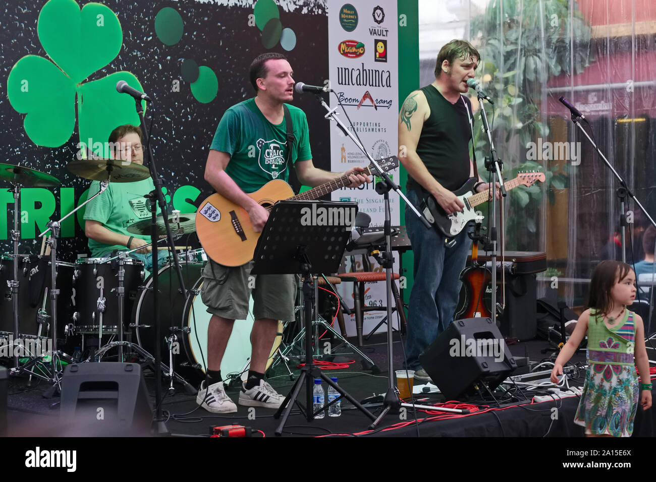 On the occasion of St. Patrick's Day, an Irish band plays at a small open-air event in Singapore, attended largely by Irish expats Stock Photo