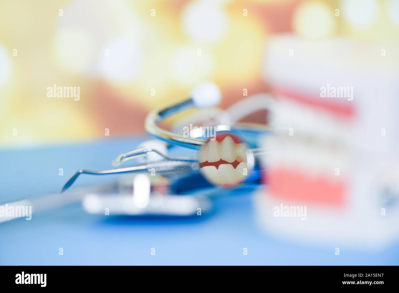 dentist tools with dentures dentistry instruments and dental hygienist checkup concept with teeth model and mouth mirror oral health , selective focus Stock Photo