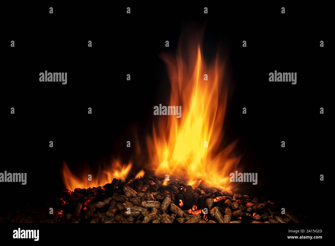 detail of the flame lit on wood pellets on a black background Stock Photo