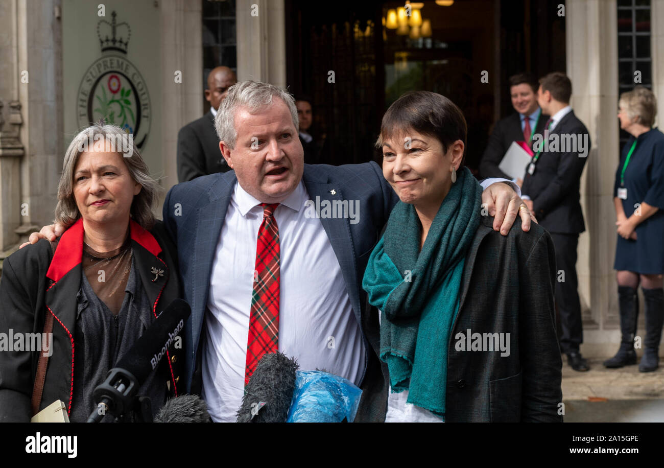 London UK, 24th Sept. 2019 The UK Supreme Court rules that Boris Johnson MP PC Prime Minister's prorogation of Parliament was unlawful Celebrations outside the Supreme Court by  liz saville roberts Plaid Cymru MP,  (left) Ian Blackford MP Scottish Nationalist leader in the UK Parliament and Caroline Lucas, Green Party MP (right) Credit Ian DavidsonAlamy Live News Stock Photo