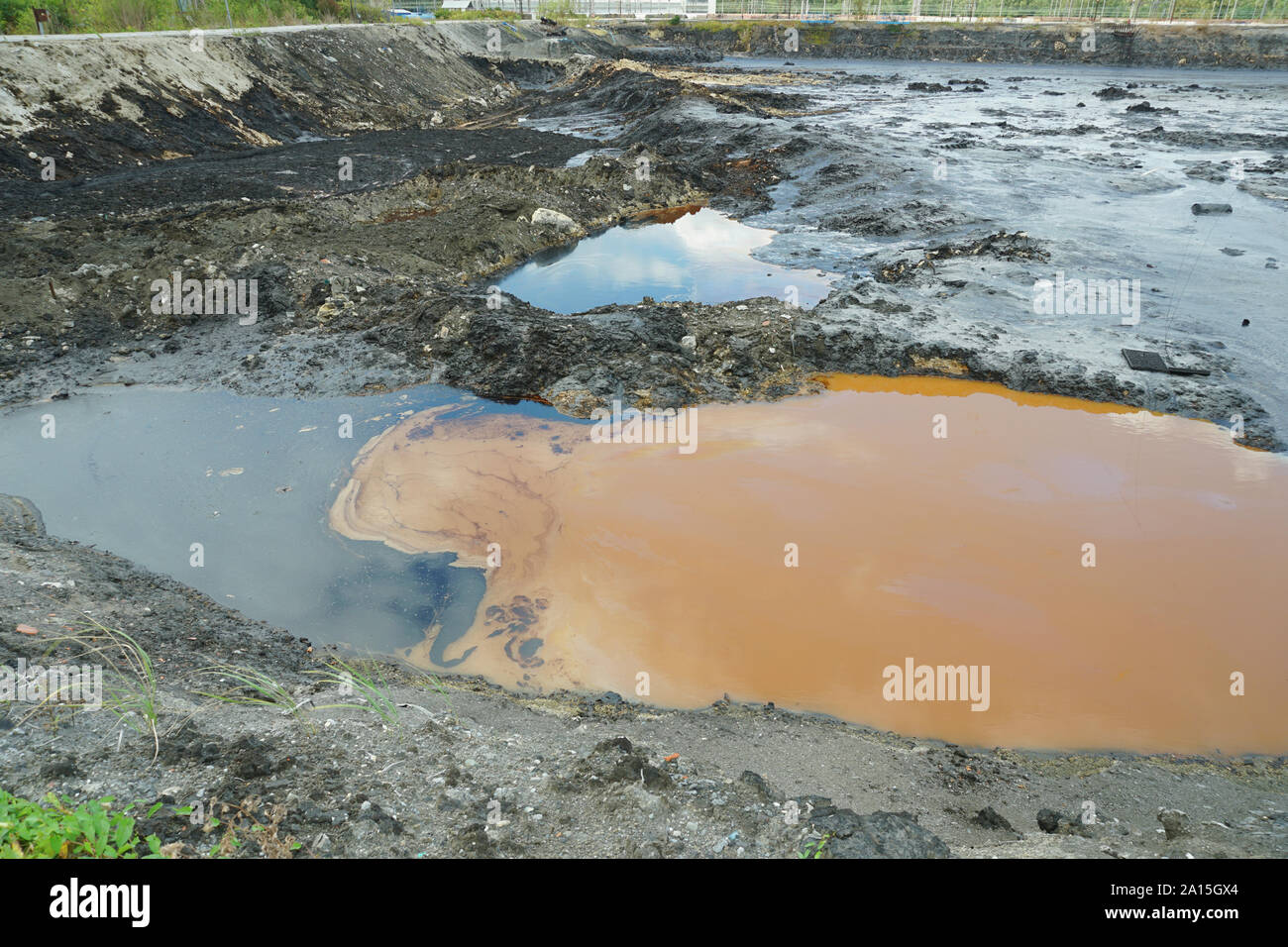 The former dump toxic waste, effects nature from contaminated soil and water with chemicals and oil, environmental disaster, contamination of the envi Stock Photo