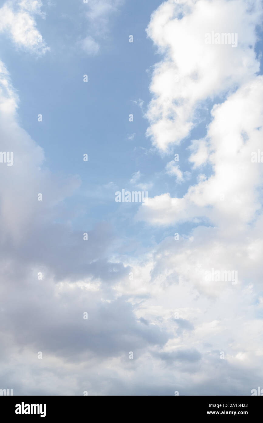 White fluffy clouds in the blue sky in summer Stock Photo - Alamy