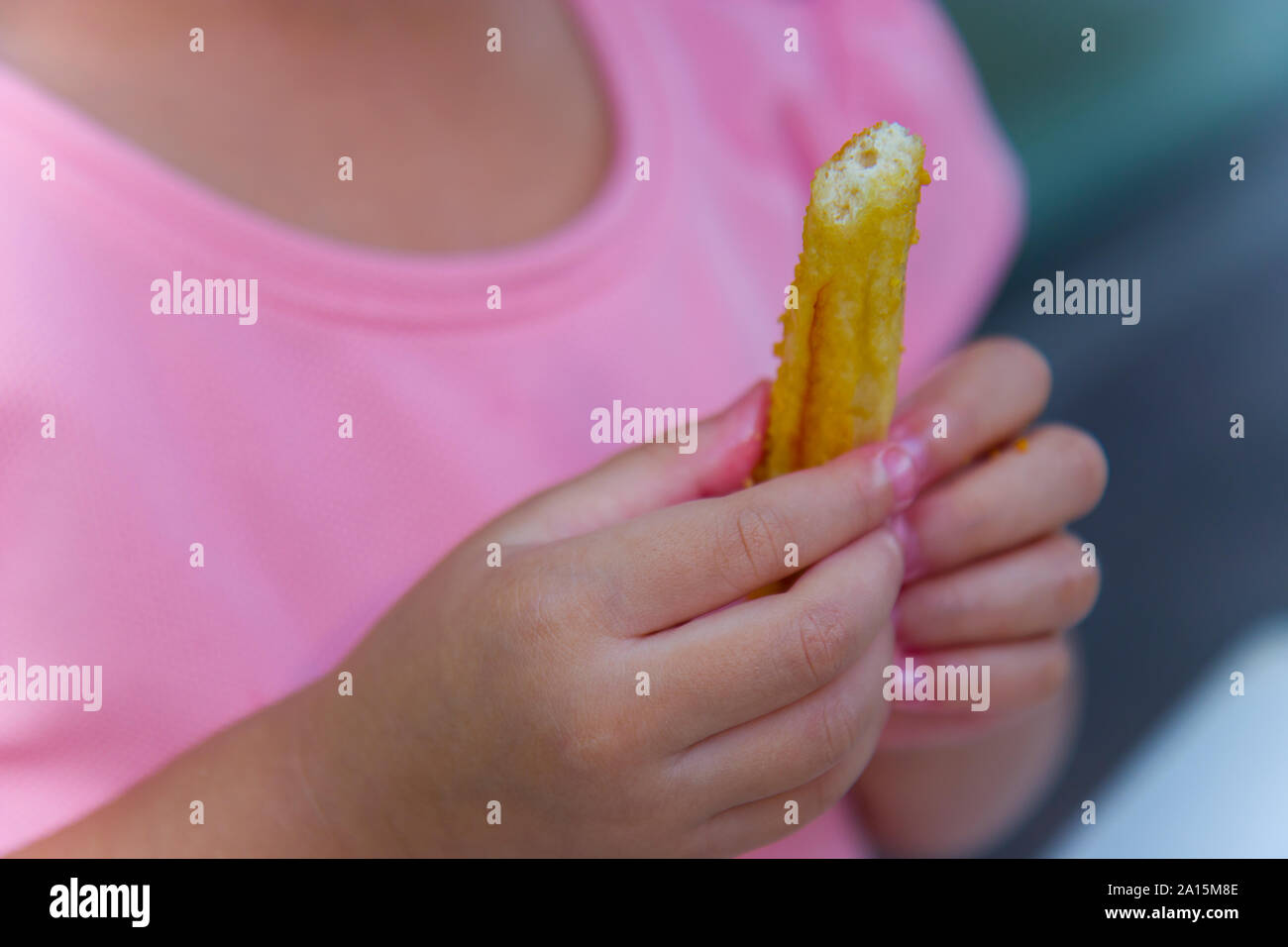 Adorable asian child smiling and enjoy eating breaded sticks at