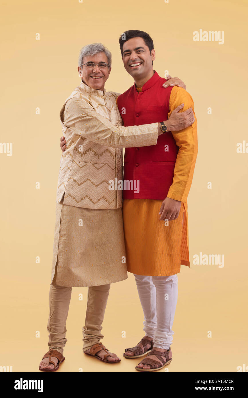 Father and son hugging each other in traditional dress Stock Photo Alamy