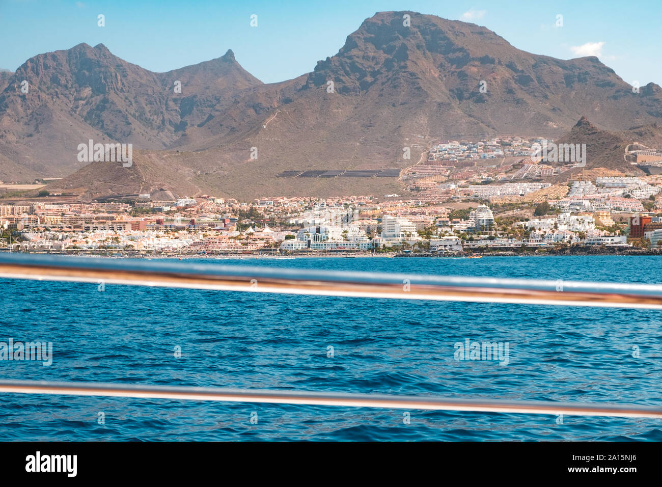 Ocean front hotels at coast view from boat on shore with mountain background Stock Photo