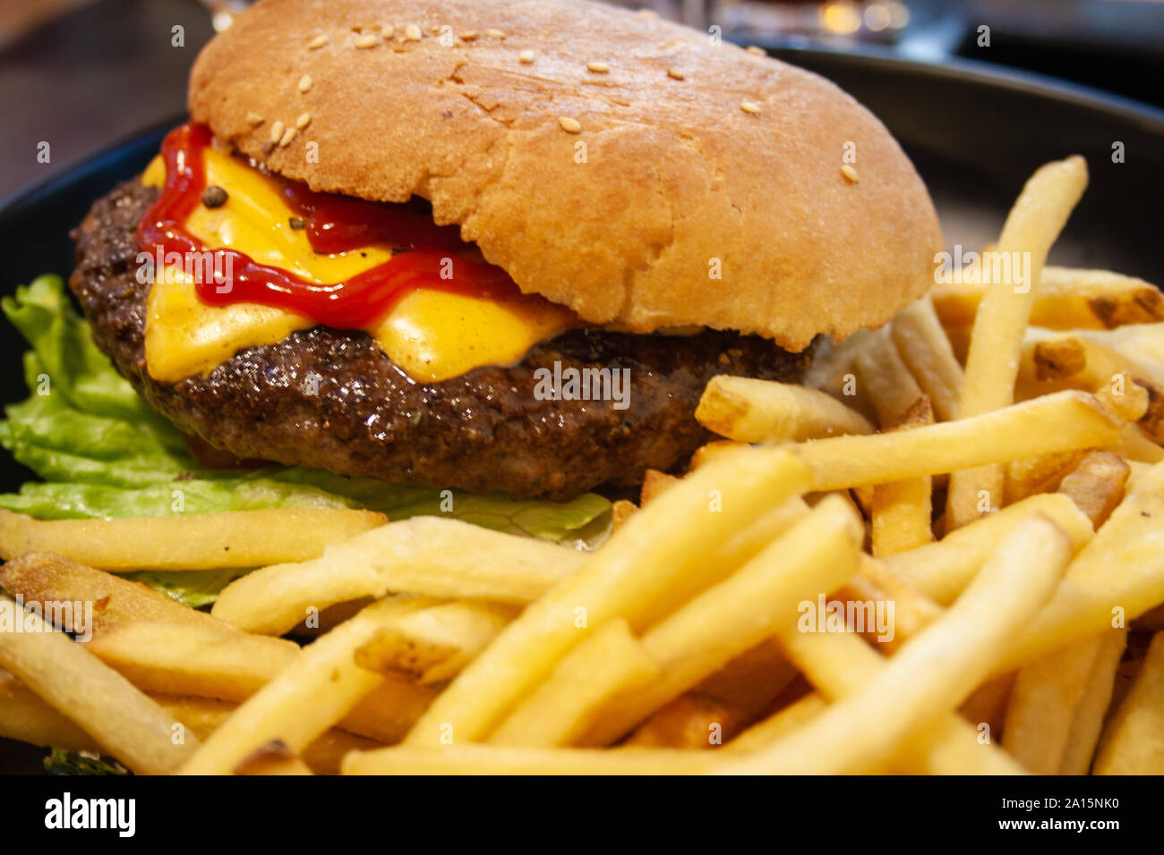 Burger, hamburger with beef, french fries, ketchup, cheese and lettuce ...