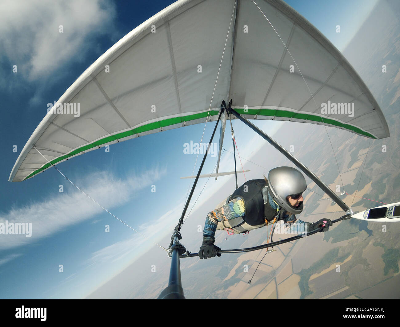 Hang glider pilot flies on high altitude. Extreme soaring without engine Stock Photo