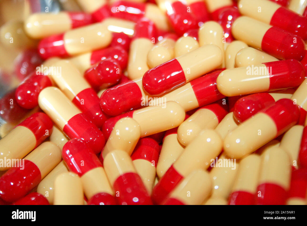 Medicine and healthy. Drugs abuse, addiction, chronic pain, medication confusion, and medical stuff. Cascade of many red and white pills and capsules Stock Photo