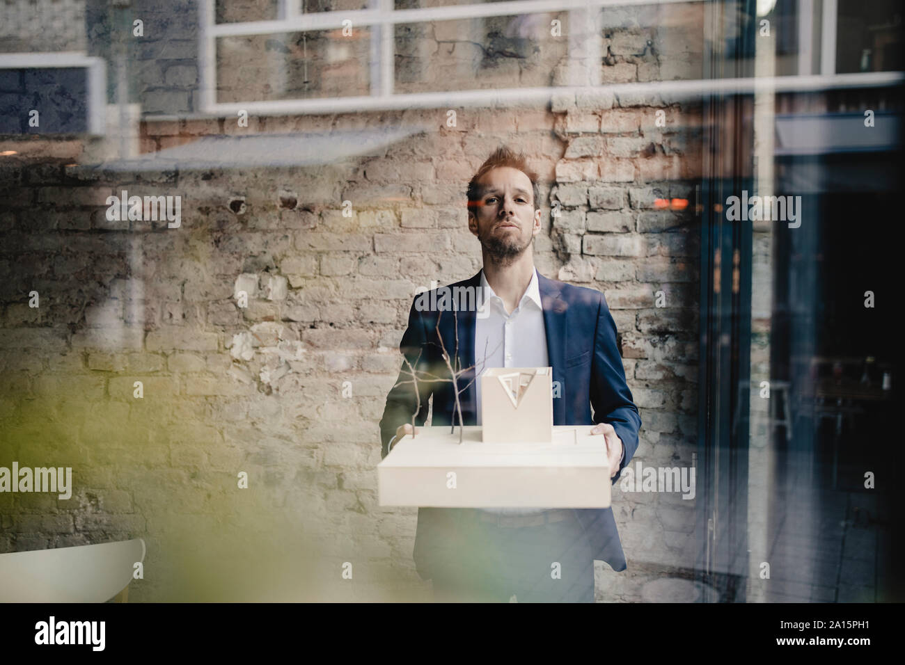 Portrait of businessman holding architectural model Stock Photo - Alamy