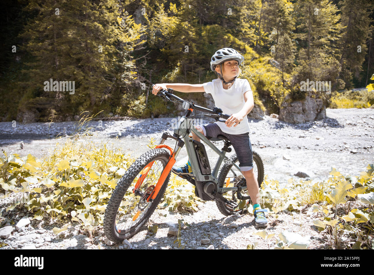 Boy in the mountains with his e-mountain bike Stock Photo
