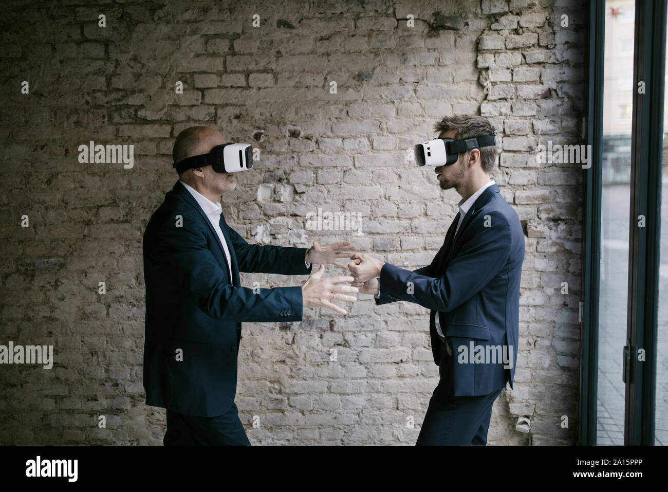 Senior and mid-adult businessman wearing VR glasses Stock Photo - Alamy