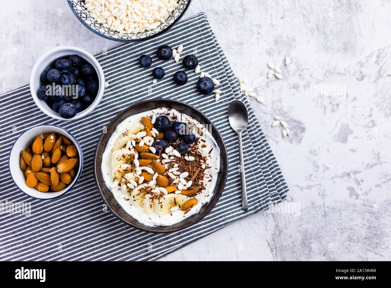 Bowl of fresh muesli, blueberries and almonds seen from above Stock Photo