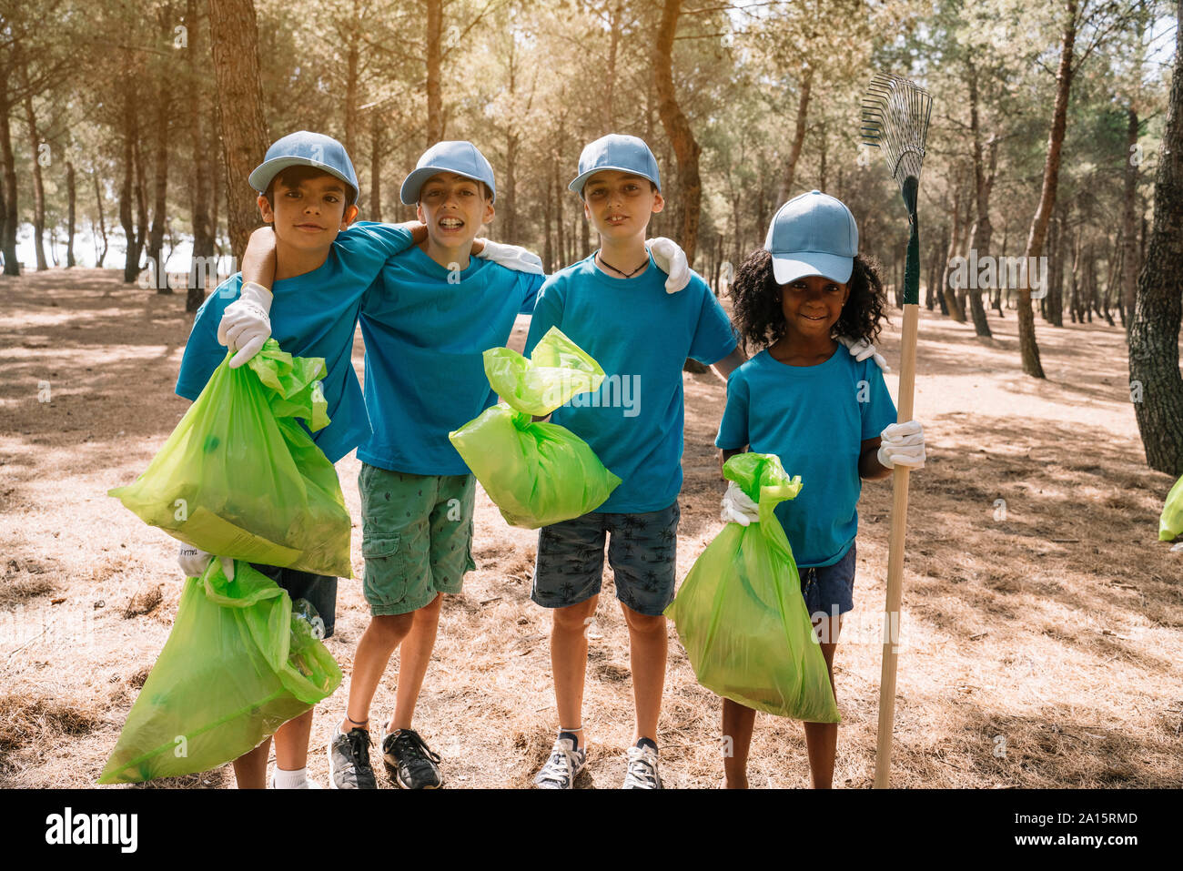 Group portrait of volunteering children collecting garbage in a park Stock Photo