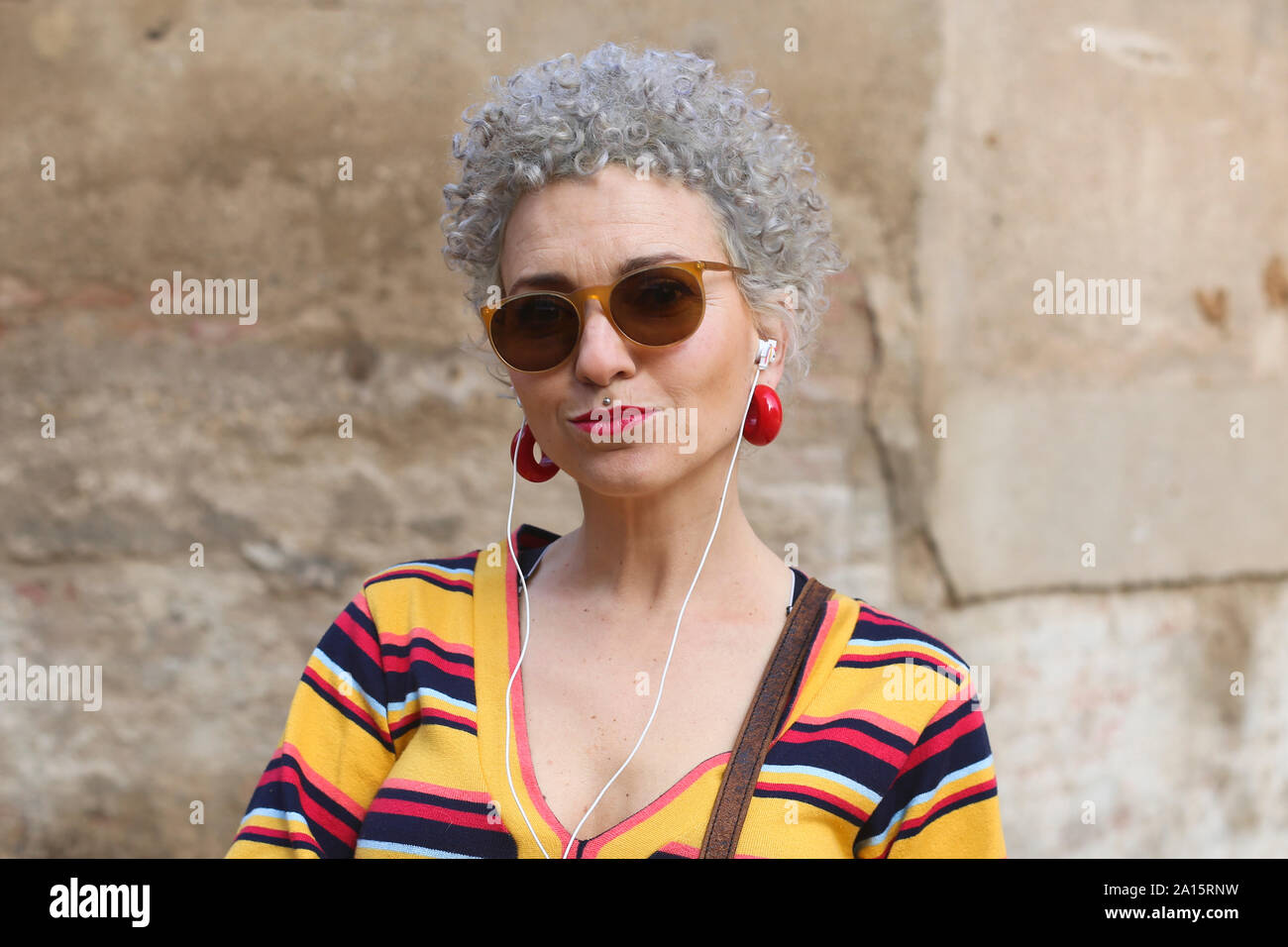 Portrait of pierced mature woman with ear phones Stock Photo