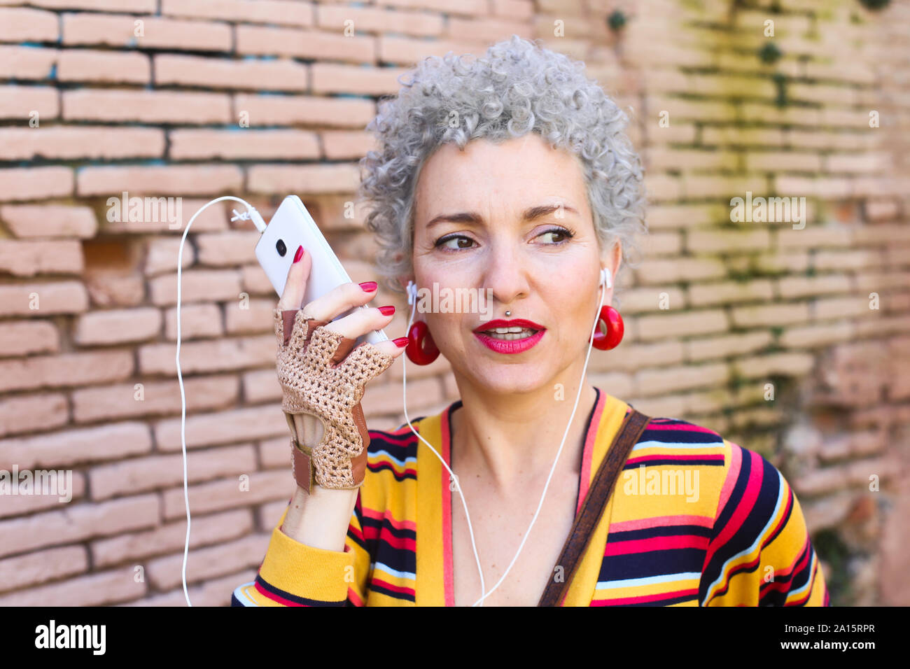 Portrait of pierced mature woman on the phone Stock Photo