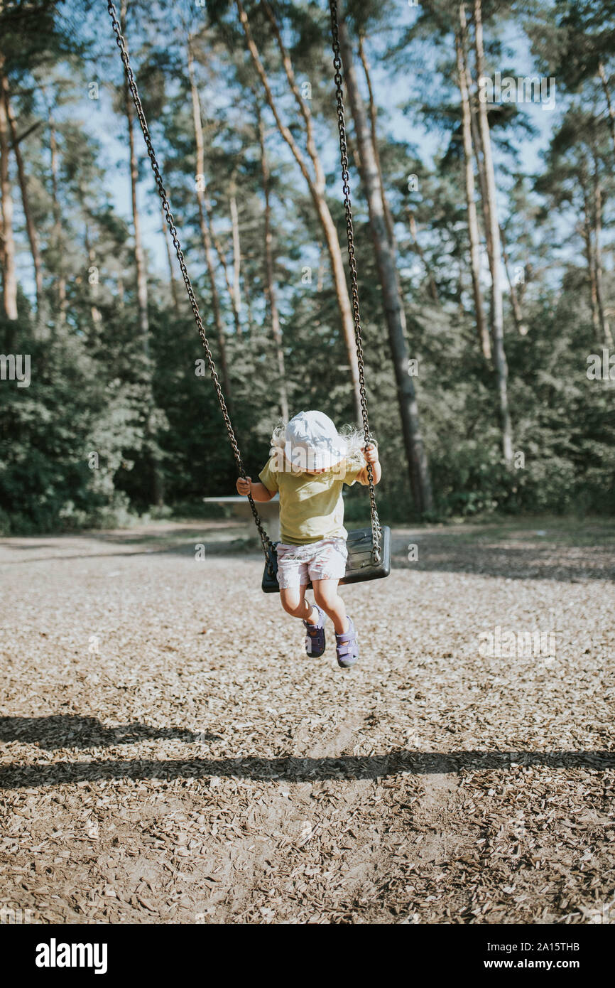 Girl on swing on a playground Stock Photo