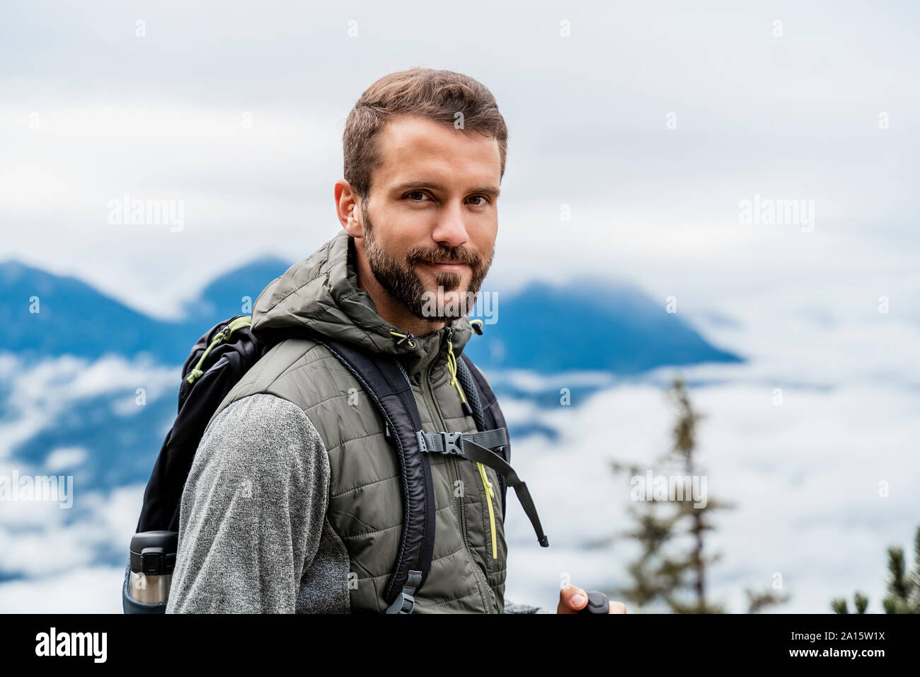 Portrait of confident young man on a hiking trip in the mountains, Herzogstand, Bavaria, Germany Stock Photo