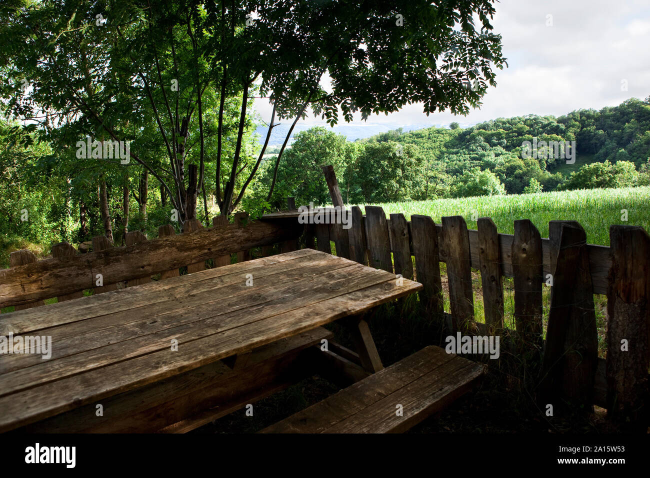 Terrace with wooden table and bench in a French countryside Stock Photo