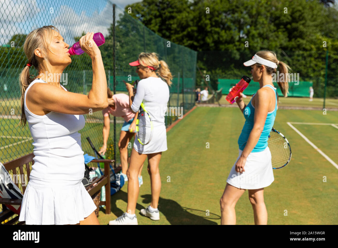Mature women at tennis club taking a break from playing Stock Photo