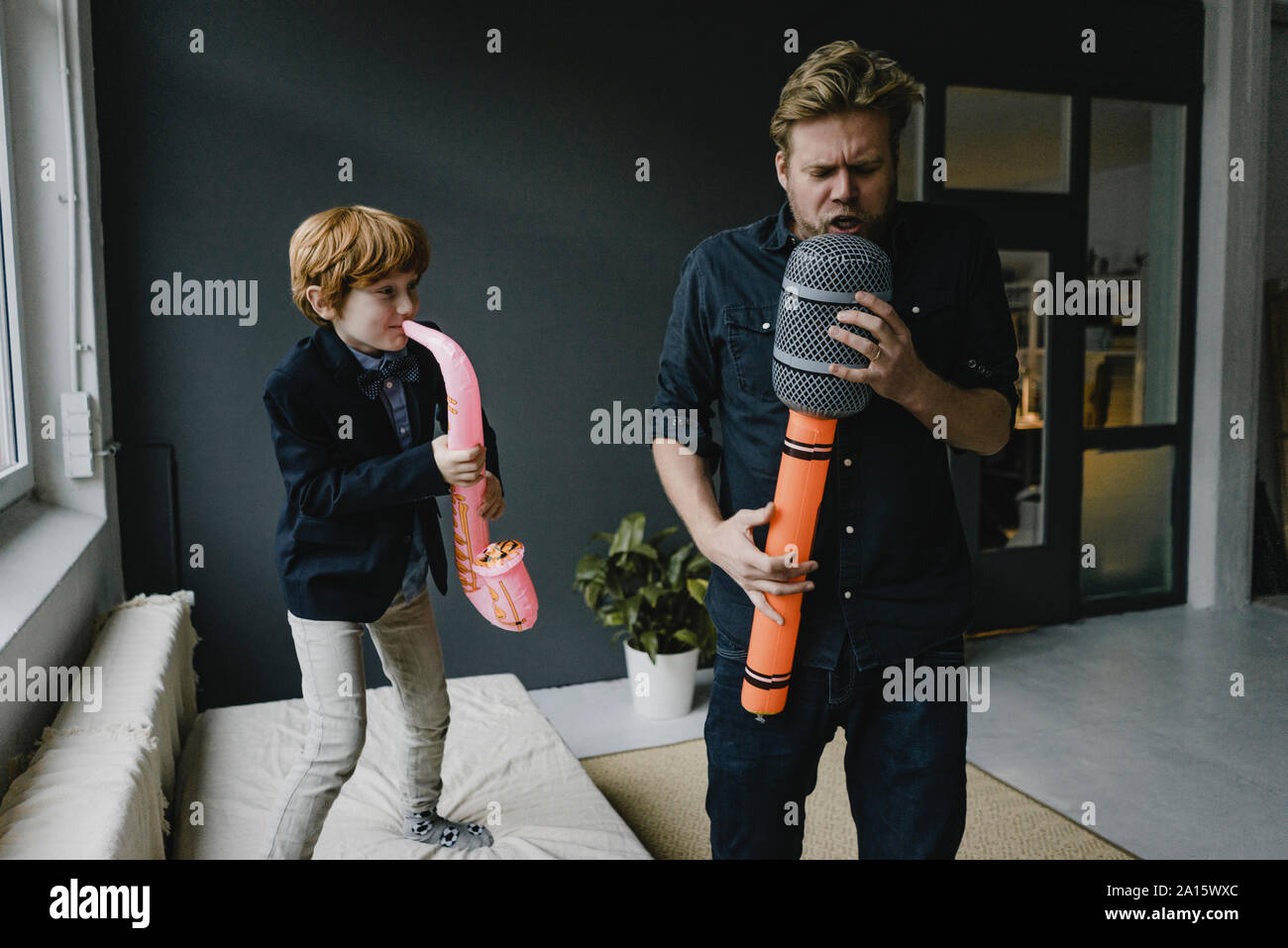 Father and son playing fun instruments Stock Photo - Alamy