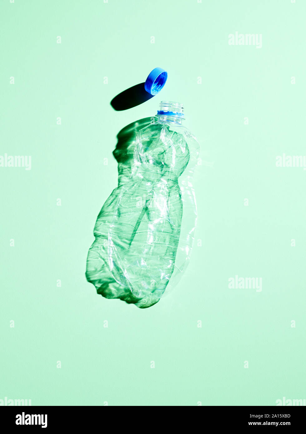 Plastic bottle on green background Stock Photo - Alamy