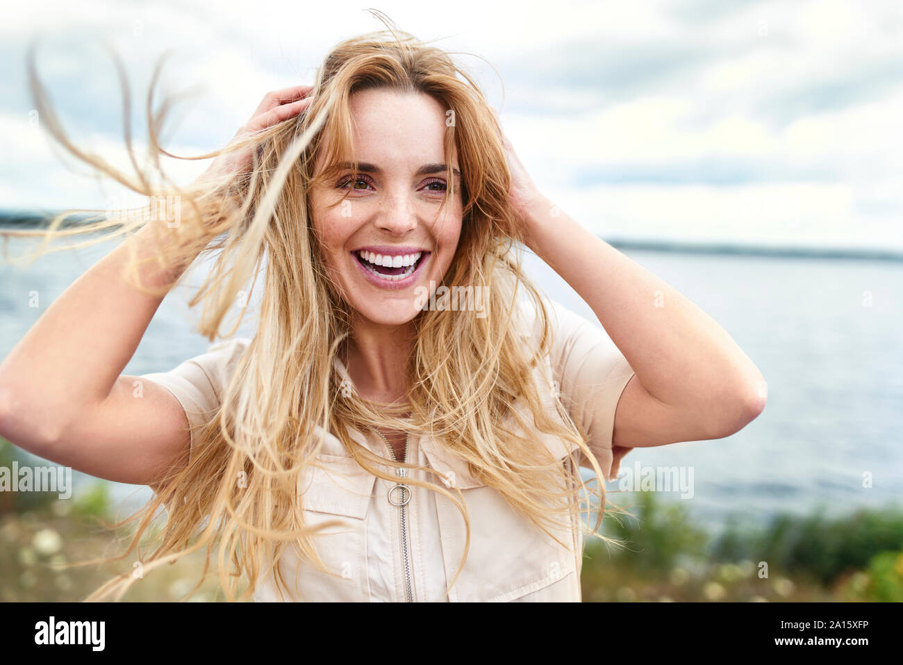 Portrait of laughing woman at the lakeside Stock Photo