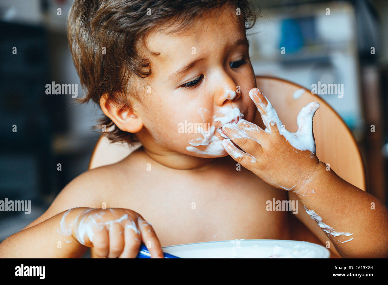 Little boy eating yogurt at home Stock Photo Alamy