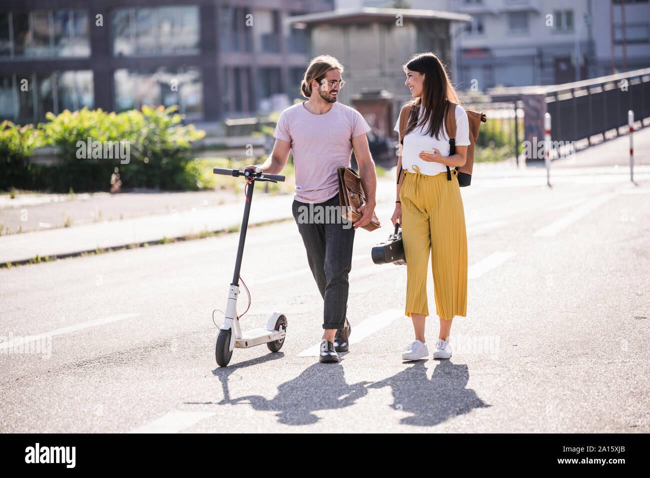 Man walking electric scooter hi-res stock photography and images - Alamy