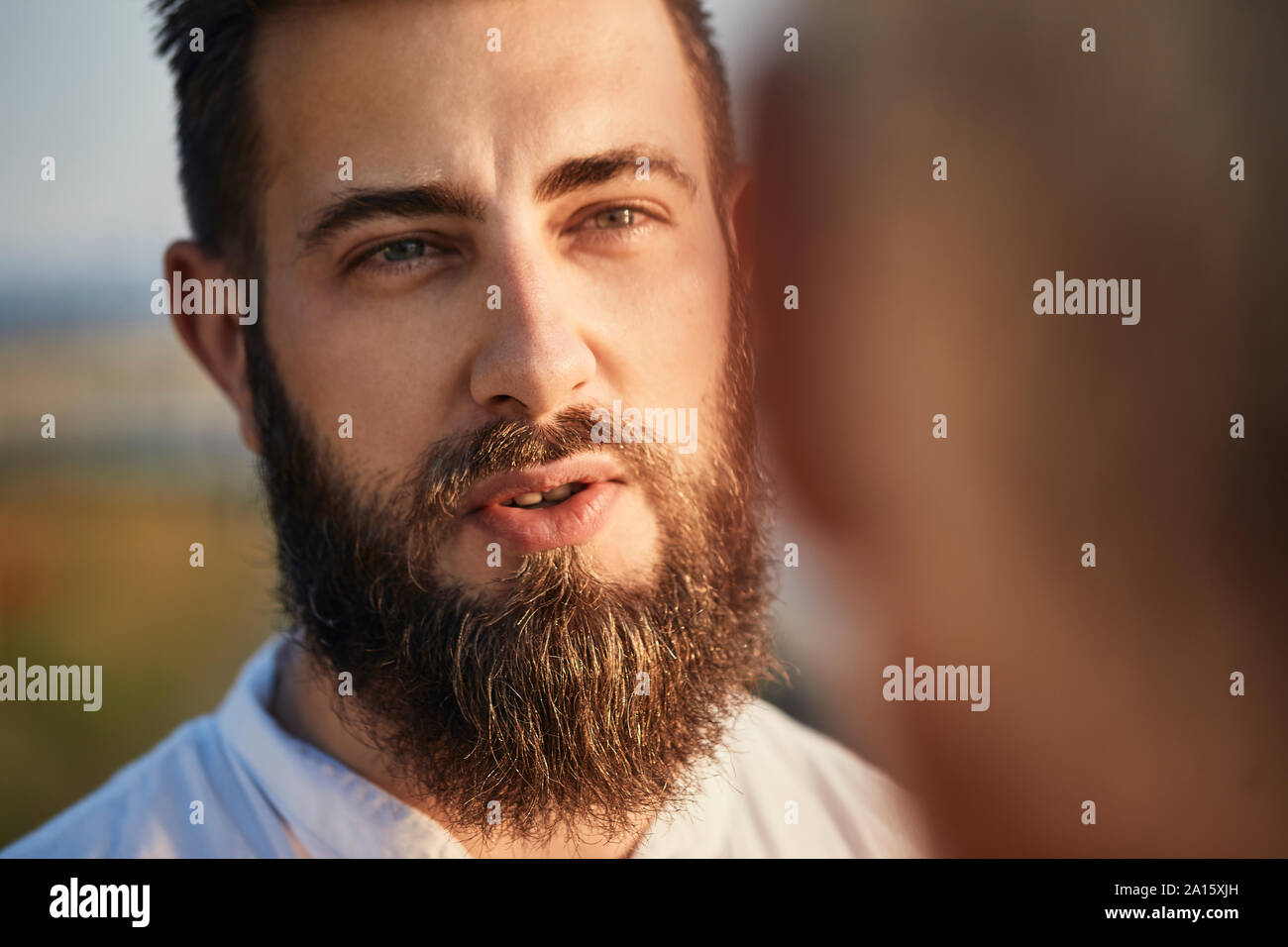 Adult son talking with father outdoors Stock Photo