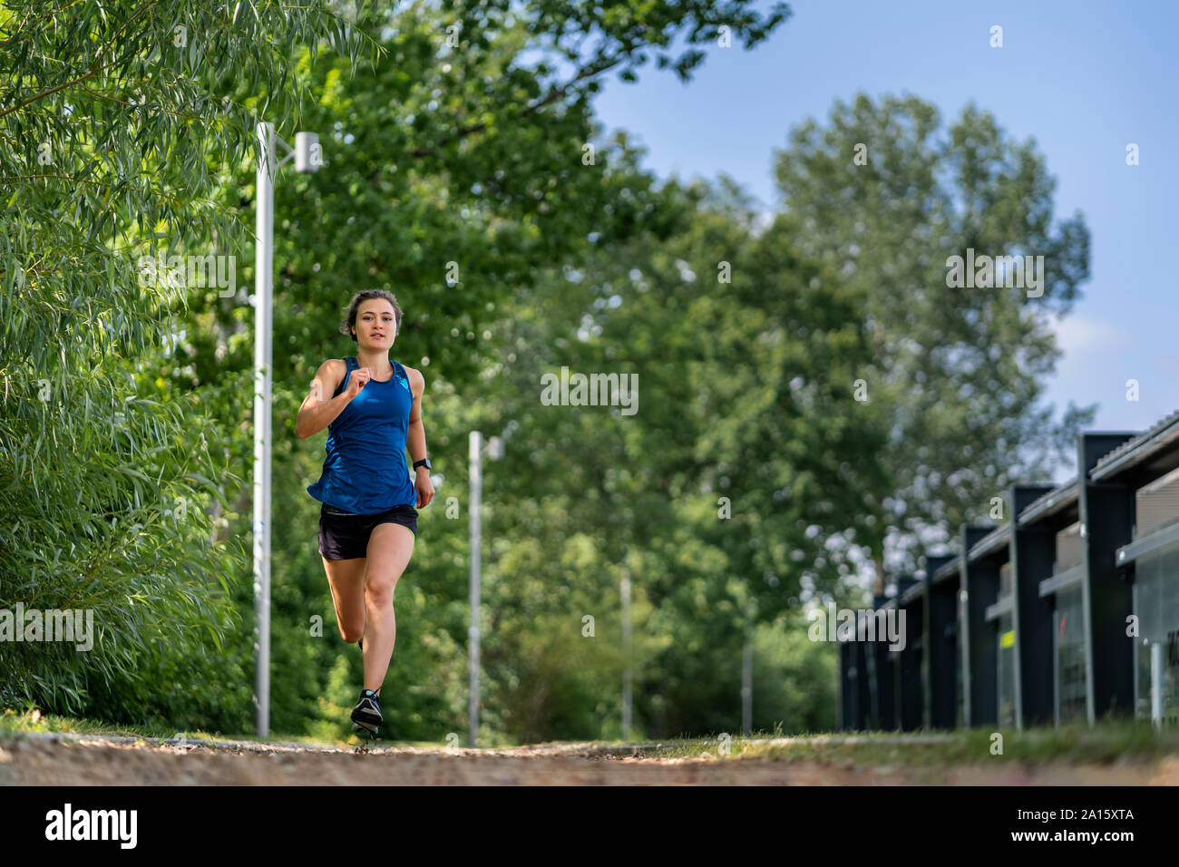 Young woman jogging on a woodchip trail Stock Photo