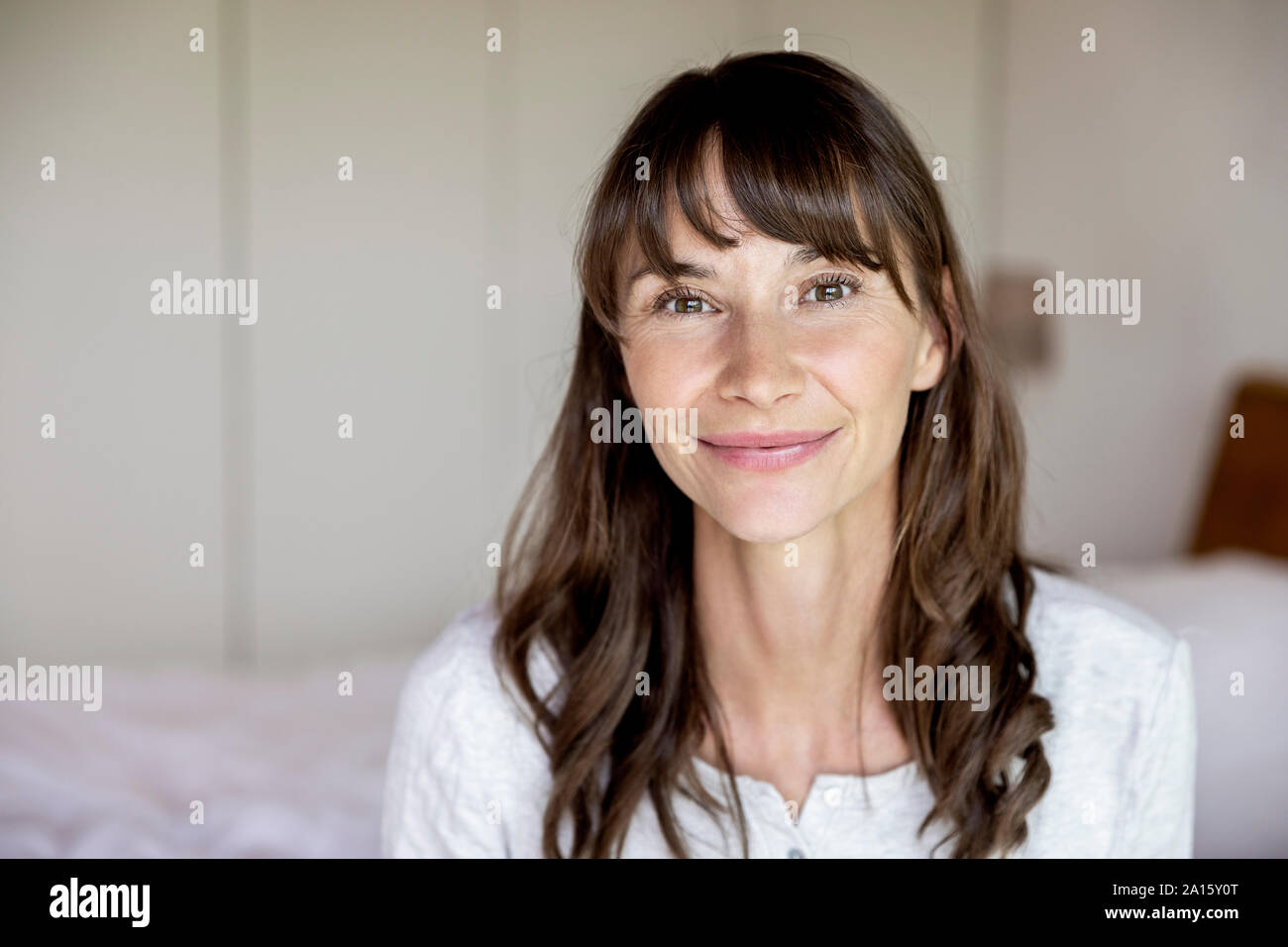 Portrait of smiling woman at home Stock Photo