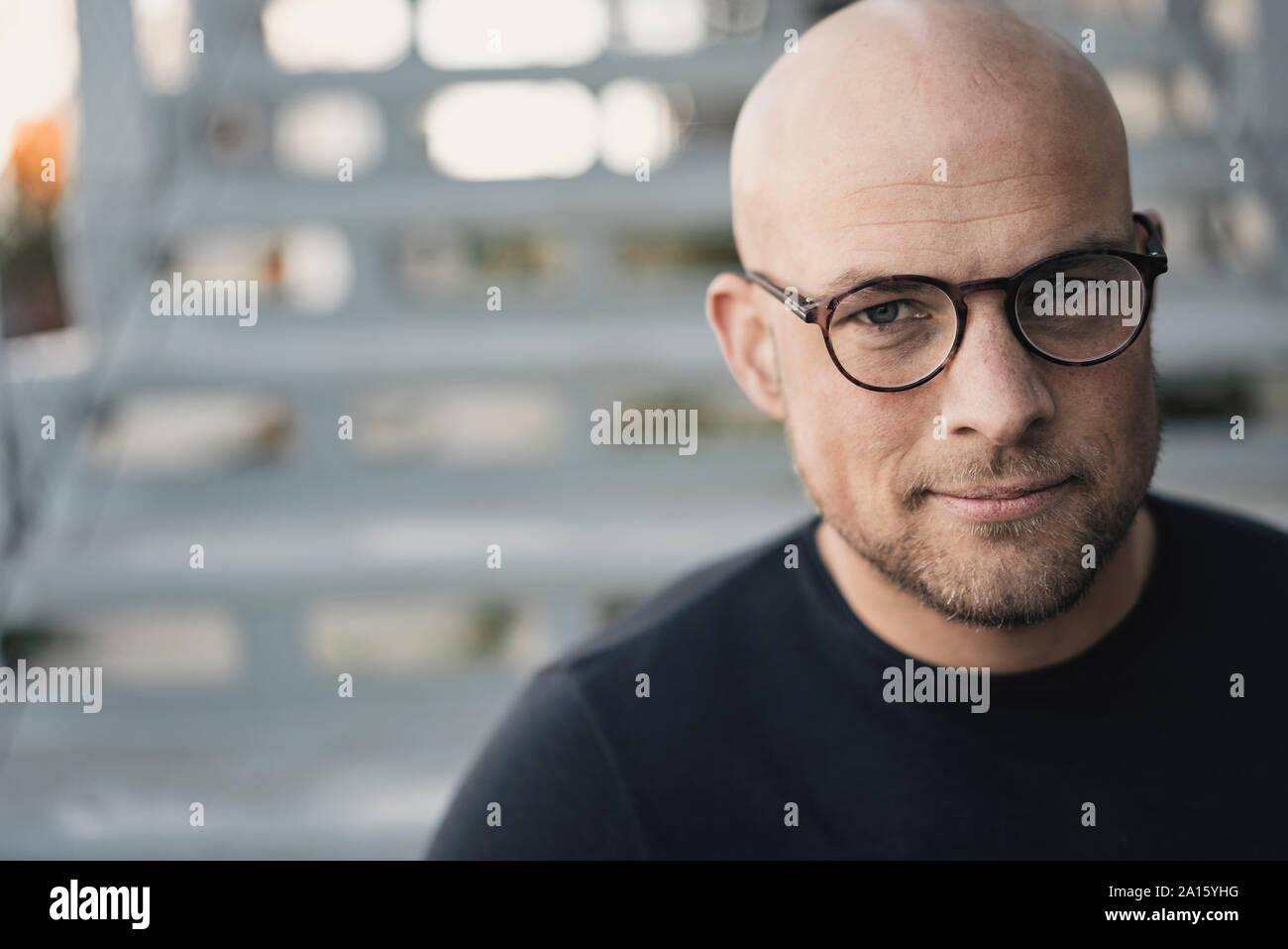 Portrait of bald man with beard wearing glasses Stock Photo