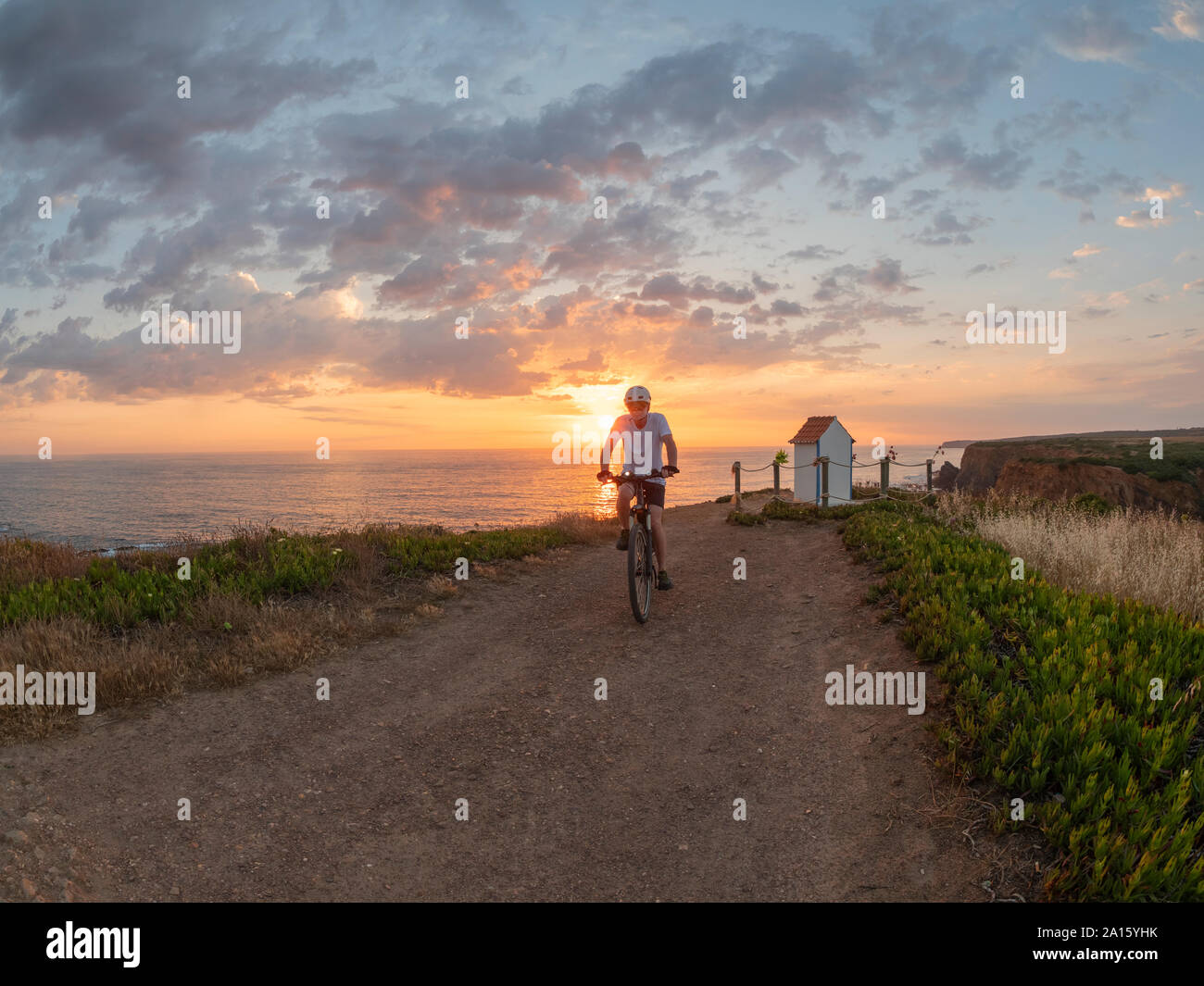 Portugal, Alentejo, senior man on e-bike at sunset Stock Photo