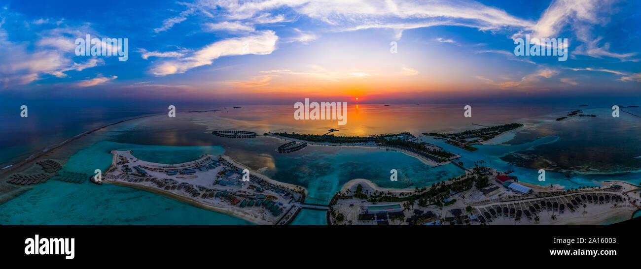 Maldives, Olhuveli island, Aerial view of resort on South Male Atoll lagoon at sunset Stock Photo