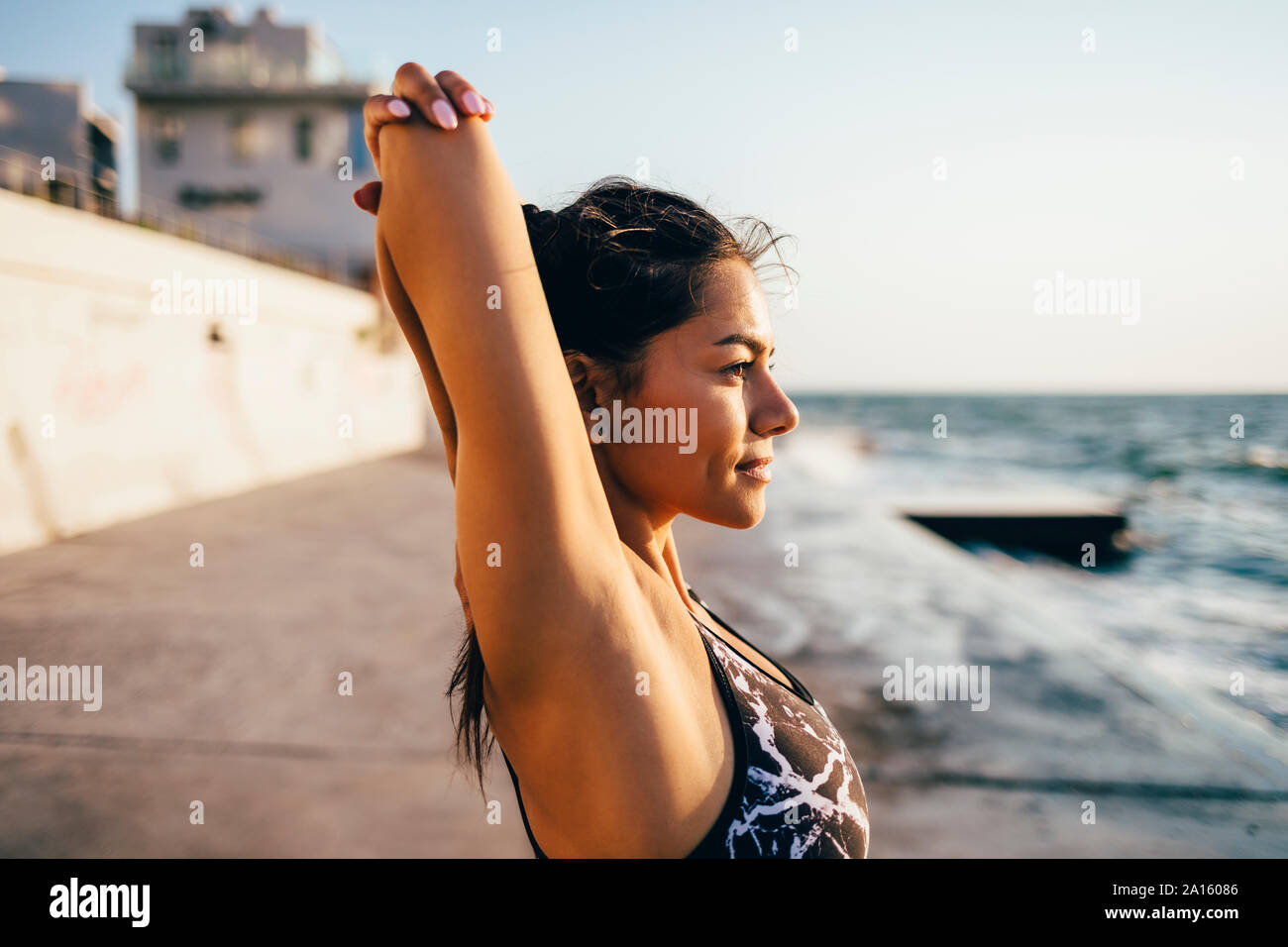 Young sportswoman stretching her arm Stock Photo