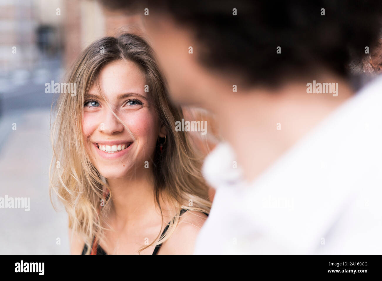 Happy young woman in love looking at boyfriend Stock Photo