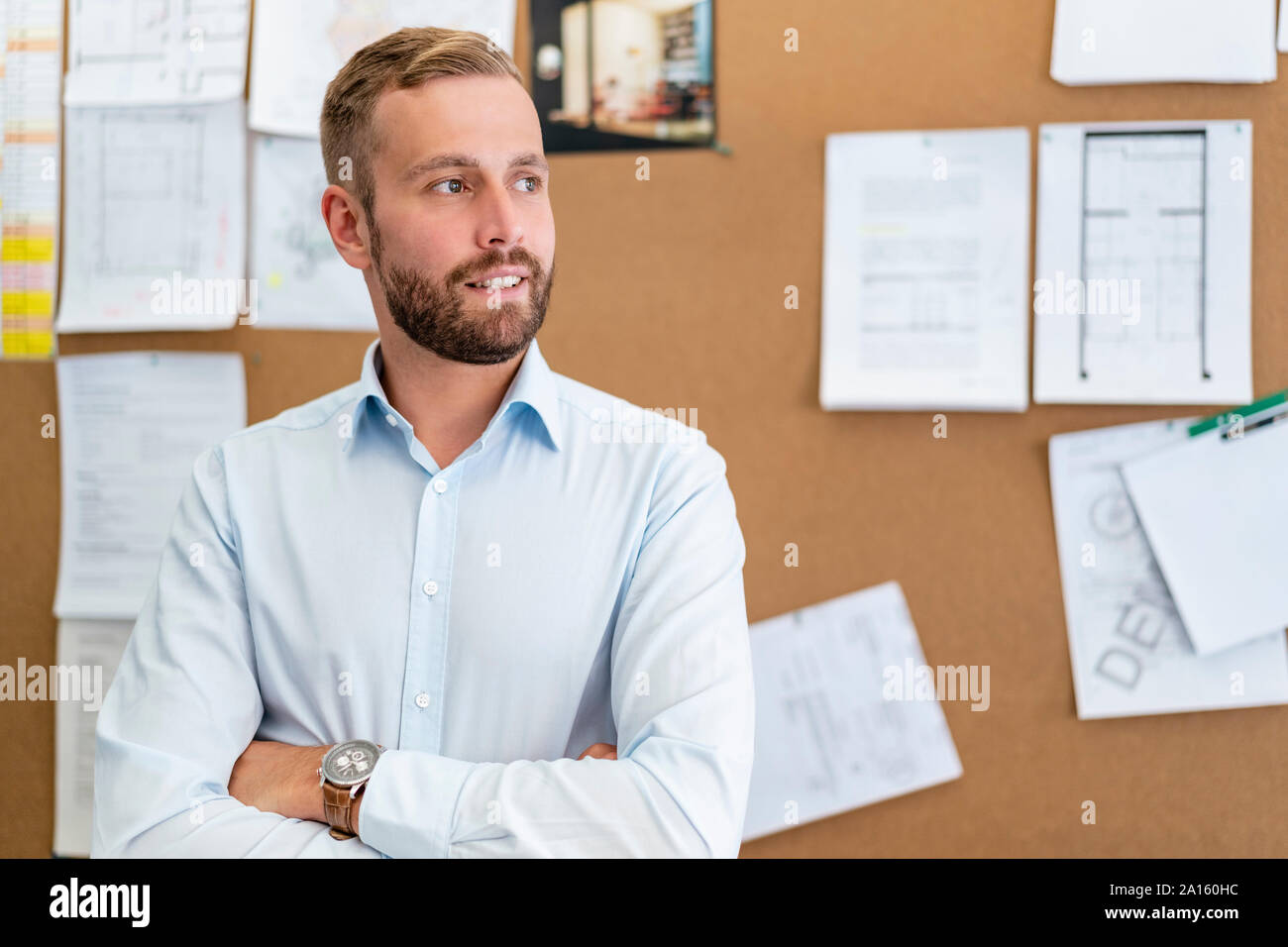 Portrait of businessman at pinboard in office Stock Photo