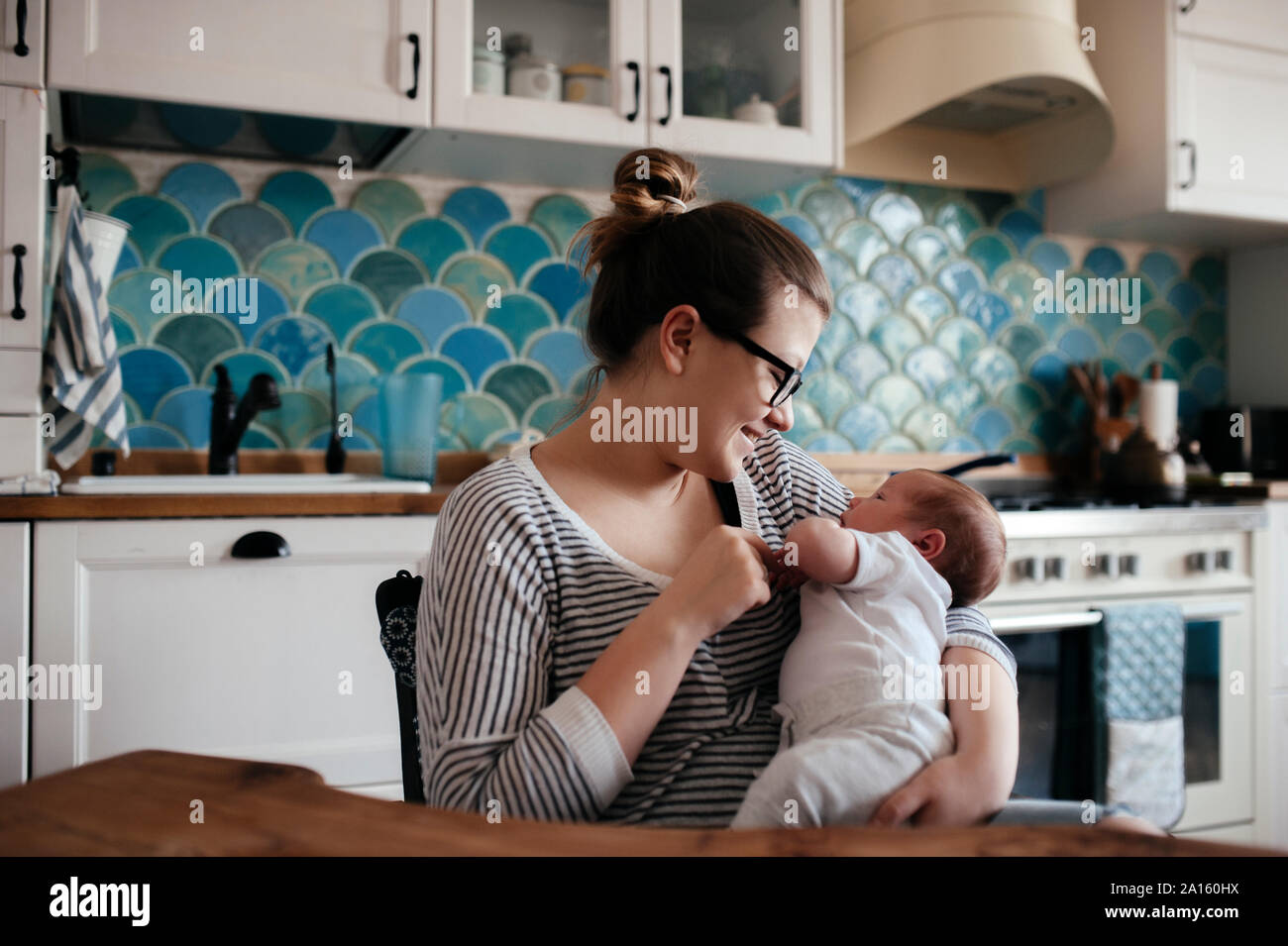 Portrait of a young woman with a baby at home Stock Photo