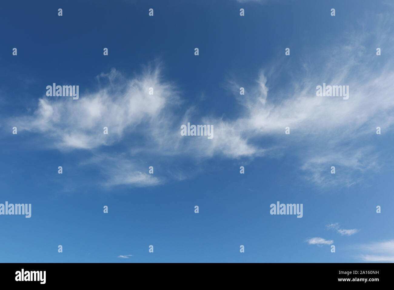 Wispy white cirrus clouds in blue sky Stock Photo - Alamy