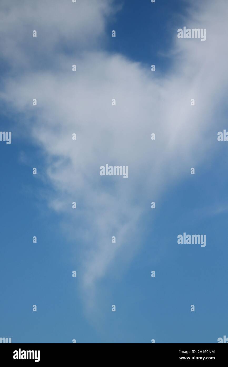 Wispy white cirrus clouds in blue sky Stock Photo