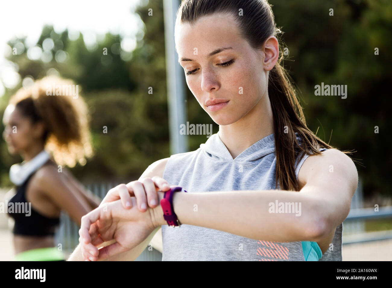 Sporty teenage girl checking her smartwatch Stock Photo