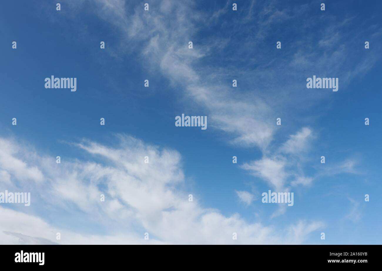Wispy white cirrus clouds in blue sky Stock Photo - Alamy