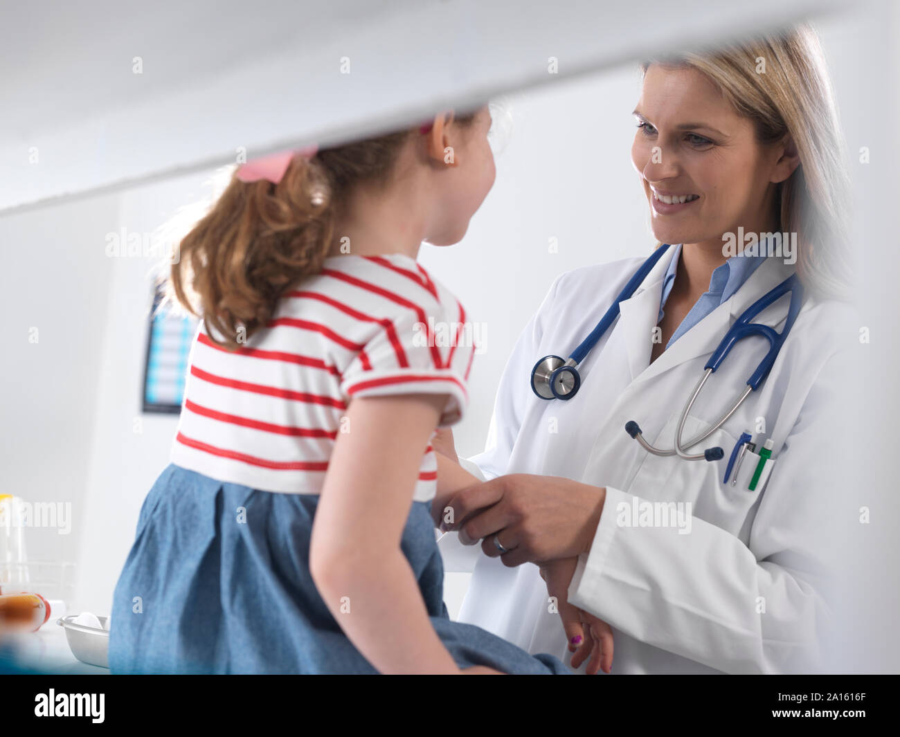 Female doctor examining and diagnosing a young girl in a clinic Stock Photo