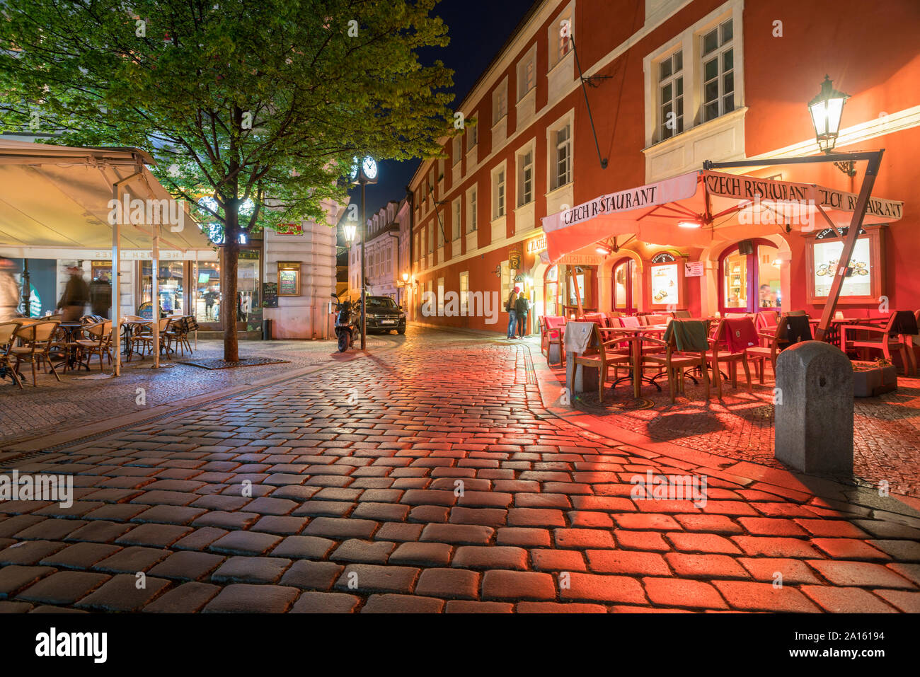 Illuminated cobblestone Street at the old town by night, Prague, Czech Republic Stock Photo