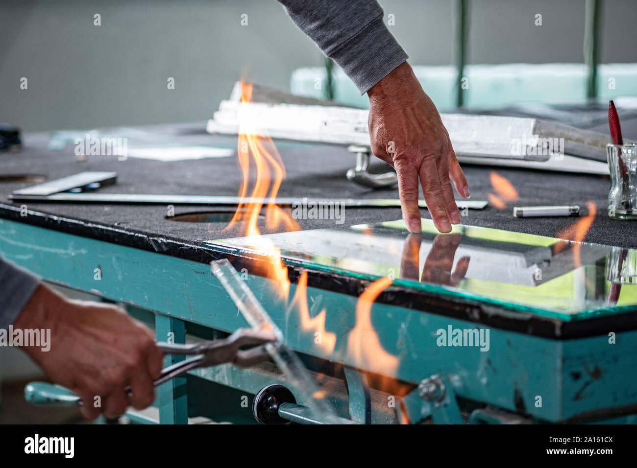 Glazing, glazier during work, flame. cutting glas Stock Photo