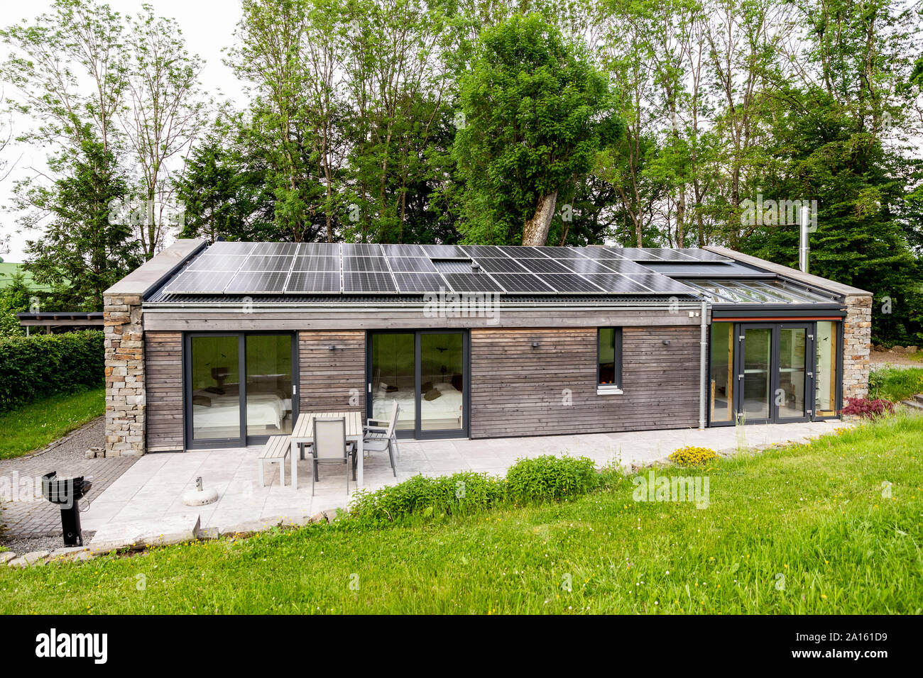 Detached house with solar panels on the roof Stock Photo