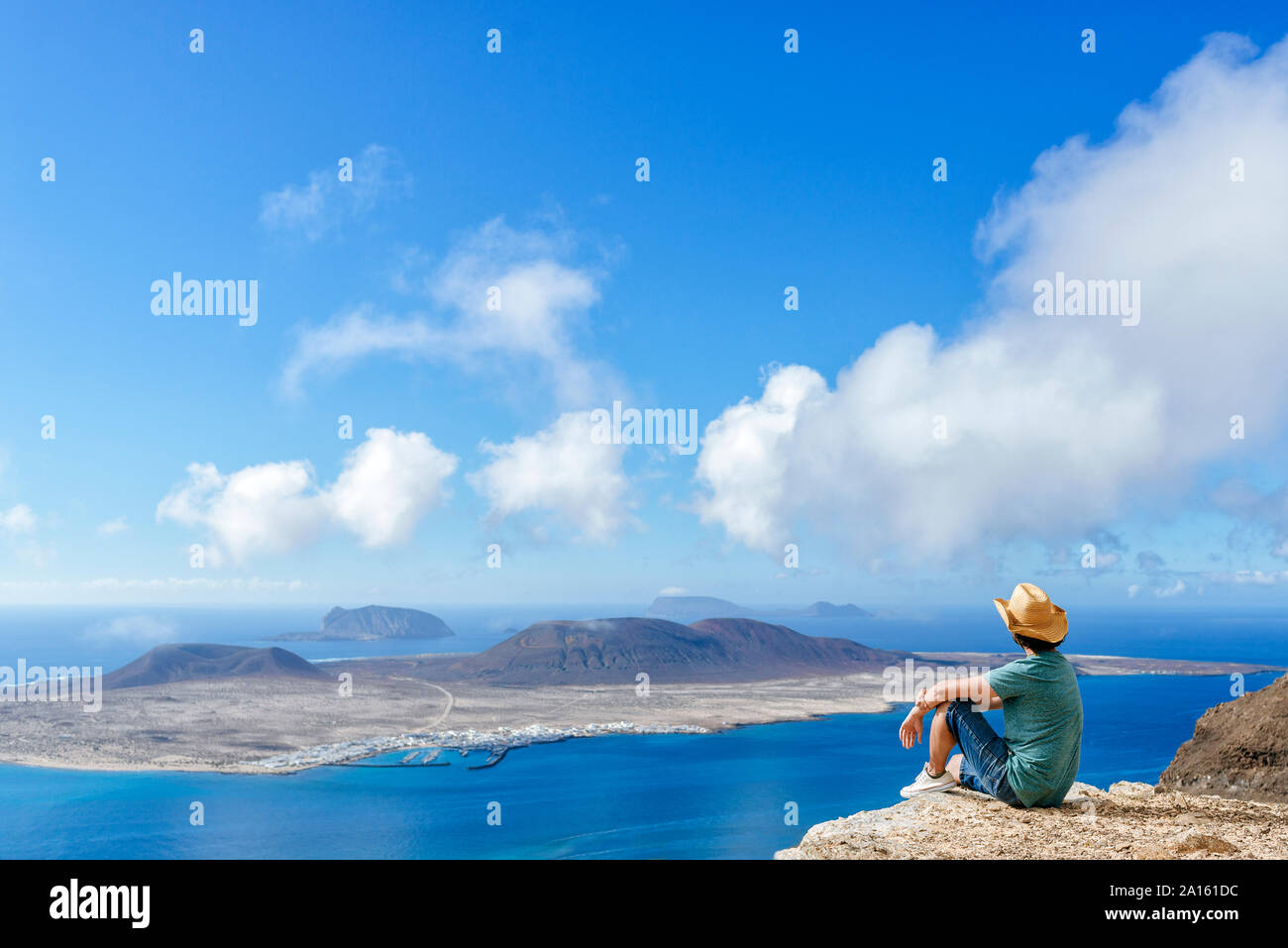 Man on viewpoint looking to La Gracioas island from Lanzarote, Canary Islands, Spain Stock Photo