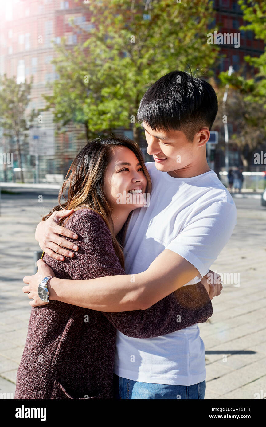 Asian couple hugging outdoors hi-res stock photography and images - Alamy