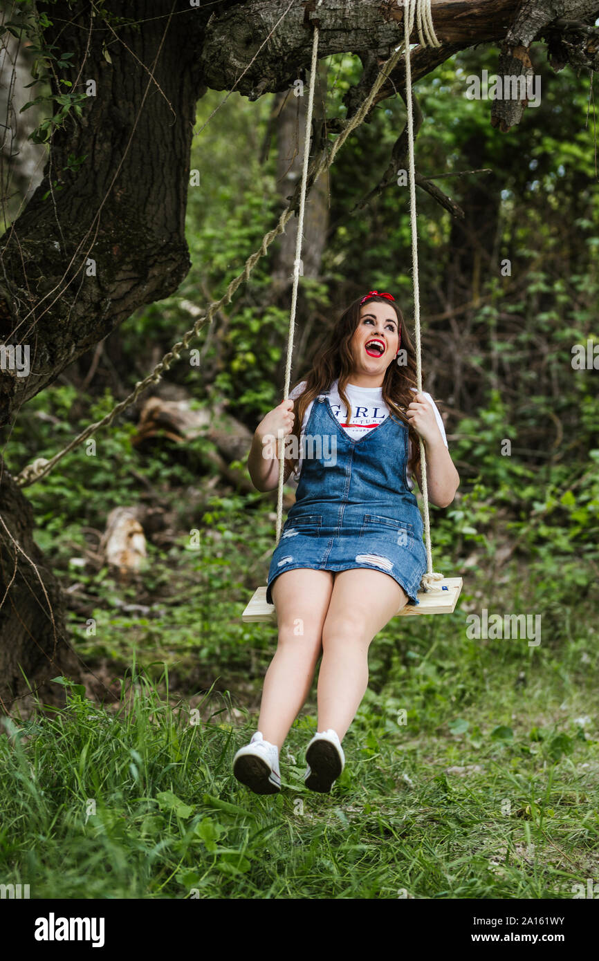 Young woman swinging on swing hi-res stock photography and images - Alamy