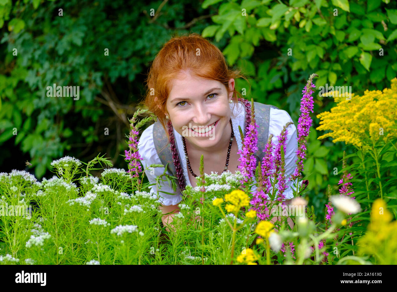 Portrait of redheaded teenage girl in garden Stock Photo
